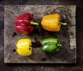 Aerial view of various bell peppers on wooden background Royalty Free Stock Photo