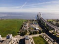 Aerial view of Vasco da Gama bridge crossing Tagus river and an industry water plant in foreground, Oriente district, Lisbon, Royalty Free Stock Photo