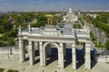 Aerial view of VDNKh exhibition main entrance arch with sculptures and USSR style Pavilion No.1, park area with fontains park