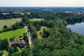 Aerial view from a vertical perspective of a house with big garden at the edge of a forest with a meadow in front of it Royalty Free Stock Photo