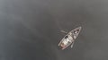 Aerial view about a very simple fishing boat on a cold autumn foggy morning near a beautiful fishing lake in Sic. Romania Royalty Free Stock Photo