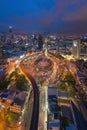 Aerial view of Victory Monument with car light trails on busy street road. Roundabout in Bangkok Downtown Skyline. Thailand. Royalty Free Stock Photo