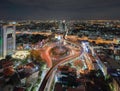 Aerial view of Victory Monument with car light trails on busy street road. Roundabout in Bangkok Downtown Skyline. Thailand. Royalty Free Stock Photo