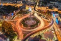 Aerial view of Victory Monument with car light trails on busy street road. Roundabout in Bangkok Downtown Skyline. Thailand. Royalty Free Stock Photo