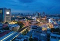 Aerial view of Victory Monument with car light trails on busy street road. Roundabout in Bangkok Downtown Skyline. Thailand.