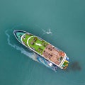 Aerial view of a Vietnamese luxury boat in Halong bay when oil spill in the sea. Ecological background. Environmental pollution Royalty Free Stock Photo