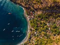 Aerial view of village with blue sea and boats, drone shot in Bali Royalty Free Stock Photo