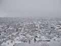 Aerial view village among the fields and forests in winter. winter landscape snow covered field and trees in countryside Royalty Free Stock Photo