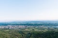 Aerial view of a village in the middle of fields and the unfocused mountains in the background on a sunny day Royalty Free Stock Photo