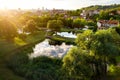 Aerial view of Vilnius cityscape shot from Subaciaus viewpoint on sunset. Clouds reflecting in three ponds of Lithuania capital`s Royalty Free Stock Photo