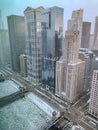 Aerial view of Wacker Drive and frozen Chicago River as sunset begins to reflect off of skyscrapers