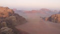 Aerial view of the Wadi Rum desert plains during sunrise.