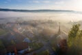 Aerial view of warm sunrise in a foggy Swiss tourist medieval town, near castle Schloss Schwandegg, Waltalinge, Stammheim. Royalty Free Stock Photo