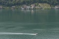 Aerial view of a water ski motorboat on Lake Lugano, with Brusino Arsizio in the background, Switzerland