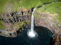 Aerial view of waterfall falling from the cliff into the sea, Denmark, Faroe Islands, Vagar Island, Gasadalur