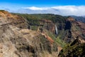 Aerial view of a waterfall in green mountains in Waimea Canyon State Park in Kauai County, Hawaii Royalty Free Stock Photo