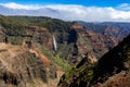 Aerial view of a waterfall in green mountains in Waimea Canyon State Park in Kauai County, Hawaii Royalty Free Stock Photo