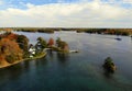 The aerial view of the waterfront residential area surrounded by striking fall foliage by St Lawrence River of Wellesley Island,