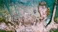 Aerial view of waves break on rocky beach. Sea waves on the beautiful colorful rocky beach. Aerial view drone 4k shot. Zoom in Royalty Free Stock Photo