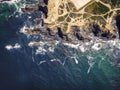 Aerial view of waves breaking on the cliffs at Cabo de Farol Sardao facing the Atlantic Ocean in Vila Nova de Milfontes, Alentejo Royalty Free Stock Photo