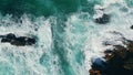 Aerial view waves breaking at coastal rocks in slow motion. Dramatic foamy sea Royalty Free Stock Photo