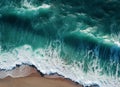 Aerial view of the waves crashing on the beach. Shot from a drone.