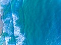 Aerial view of Waves crashing on sandy shore,Sea surface ocean waves background,Top view beach background Royalty Free Stock Photo