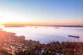 Aerial view of West Vancouver and Vancouver, sunrise ocean cityscape, cargo ships, Burrard Inlet, drone footage.