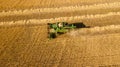 Aerial view of wheat harvest. Drone shot flying over combine harvester working on wheat field Royalty Free Stock Photo