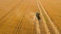 Aerial view of wheat harvest. Drone shot flying over combine harvester working on wheat field Royalty Free Stock Photo