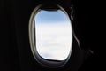 Aerial View Of White Clouds From Airplane Window With Silhouette Man Face Look Outside