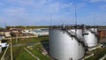 Aerial view white fuel storage tank in oil refinery plant. Stock. Top view white Industrial tanks for petrol and oil