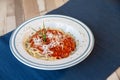 Aerial view of white plate of spaghetti bolognese with tomato sauce, meat and cheese Royalty Free Stock Photo