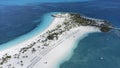 Aerial view of white sandy beaches surrounded by clear turquoise water in the Bahamas