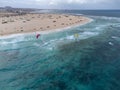 View on white sandy Corallejo beach, Atlantic ocean water and kite surfers at winter Royalty Free Stock Photo