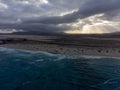 View on white sandy Corallejo beach, Atlantic ocean water and kite surfers at winter Royalty Free Stock Photo