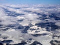 Aerial view of white snowscape and cloudscape covering landscape below in winter, wallpaper, in white, Scandinavia, Royalty Free Stock Photo