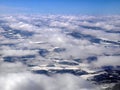 Aerial view of white snowscape and cloudscape covering landscape below in winter, wallpaper, in white, Scandinavia, Royalty Free Stock Photo