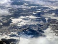 Aerial view of white snowscape and cloudscape covering landscape below in winter, wallpaper, in white, Scandinavia, Royalty Free Stock Photo