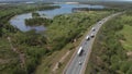 Aerial View of White Truck Passing Busy highway/ Highway Overpass/ Overdrive/ Bridge. Cars and trucks go on the road on