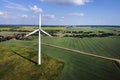 Aerial view of wind turbine and agricultural field, summer rural landscape. Wind power, sustainable and renewable energy Royalty Free Stock Photo