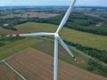 Aerial view on wind turbine, road, wheat fields and forest