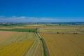 Aerial view of wind turbine. Windmills at harvest time, fields from above. Agricultural fields on a summer day. Renewable Energy Royalty Free Stock Photo