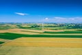 Aerial view of wind turbine. Windmills at harvest time, fields from above. Agricultural fields on a summer day. Renewable Energy Royalty Free Stock Photo