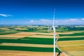 Aerial view of wind turbine. Windmills at harvest time, fields from above. Agricultural fields on a summer day. Renewable Energy Royalty Free Stock Photo