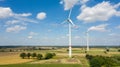 Aerial view of wind turbines windmills against the sky with clouds. Alternative ecological energy production in Germany. Change