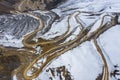 Aerial view of the winding dirt road on snow mountain Royalty Free Stock Photo