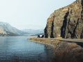 Aerial view of a winding mountain road leading to a stunning lake, Okanagan, Canada