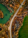 Aerial view of winding river and road in golden colored fall forest Royalty Free Stock Photo