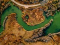 Aerial view of winding river and road in golden colored fall forest Royalty Free Stock Photo